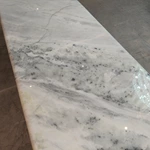 Oval White Marble TV Stand with Cream Diamond-Stitched Leather Trim and Dark Glossy Panels